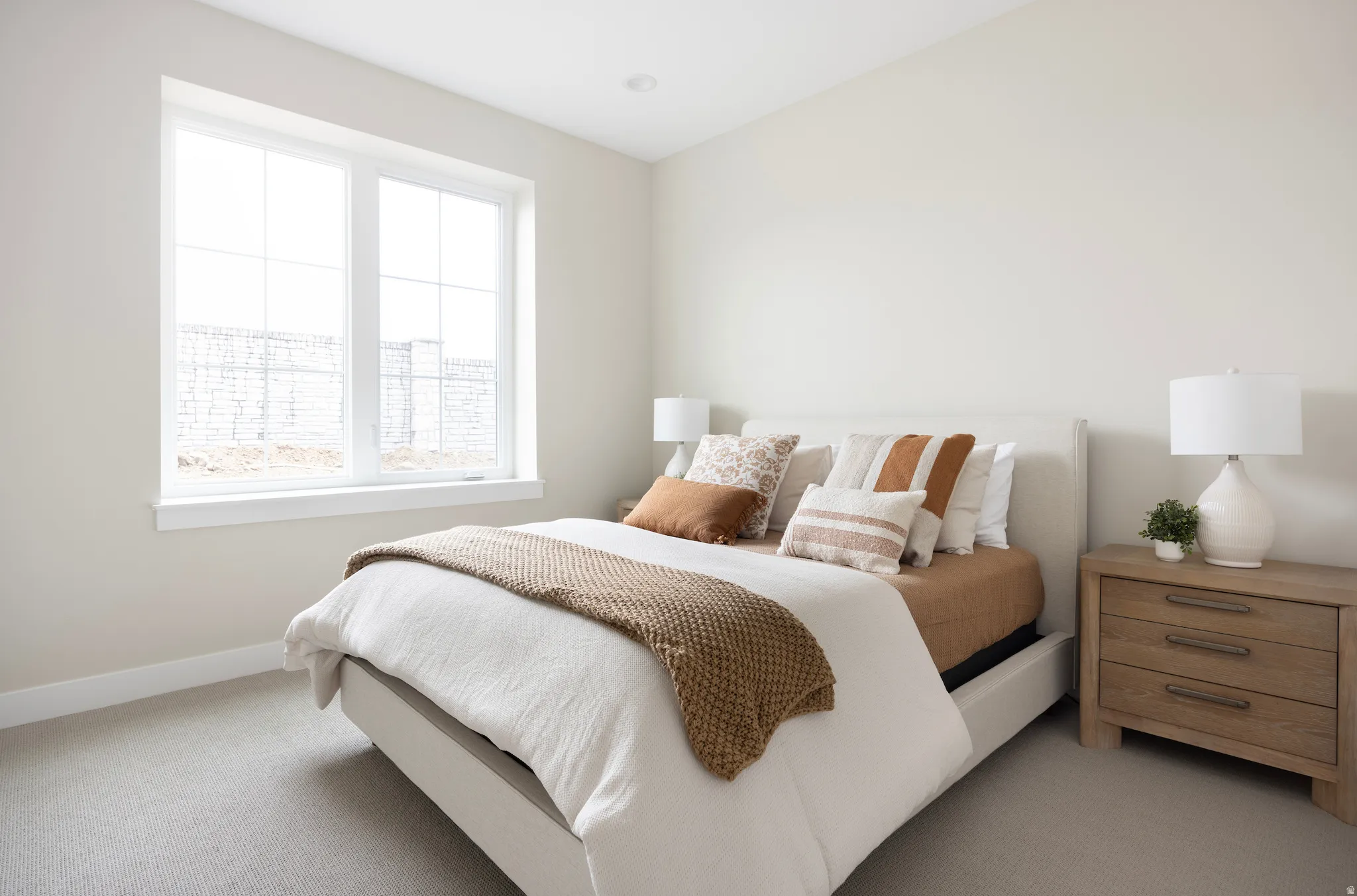 Bedroom featuring light colored carpet