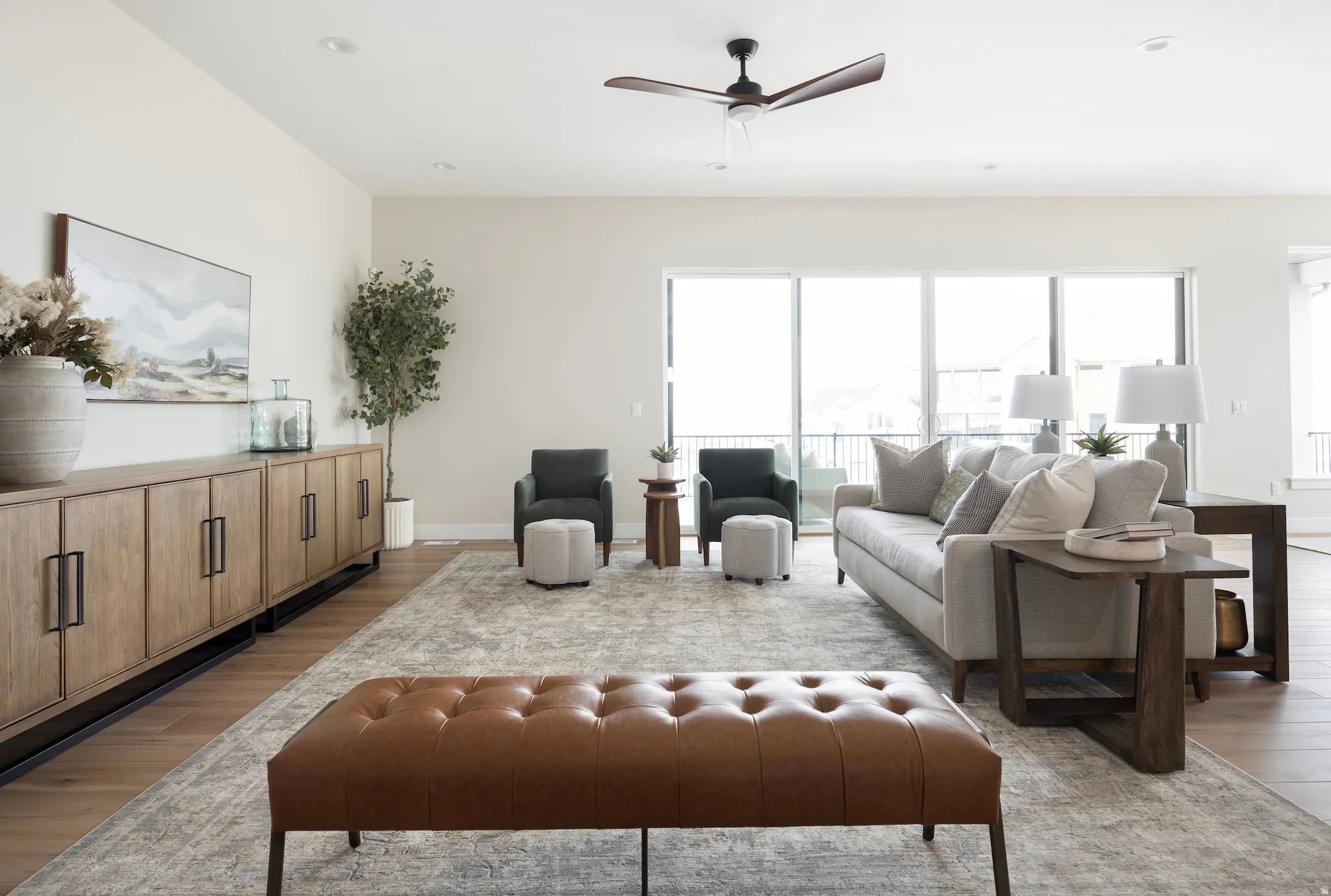 Living room with light wood finished floors, ceiling fan, healthy amount of natural light, and recessed lighting