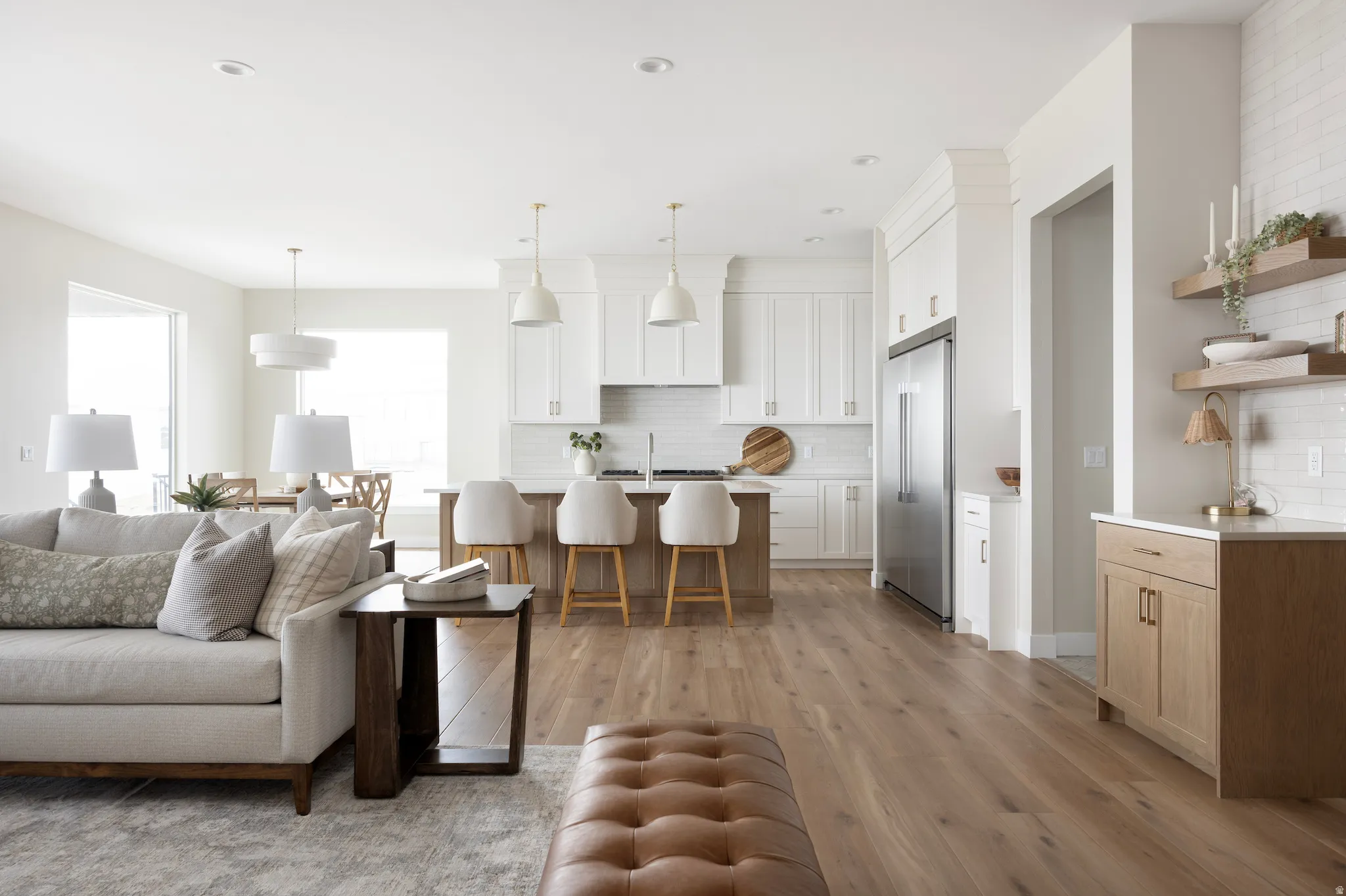 Living area with light wood-type flooring and recessed lighting