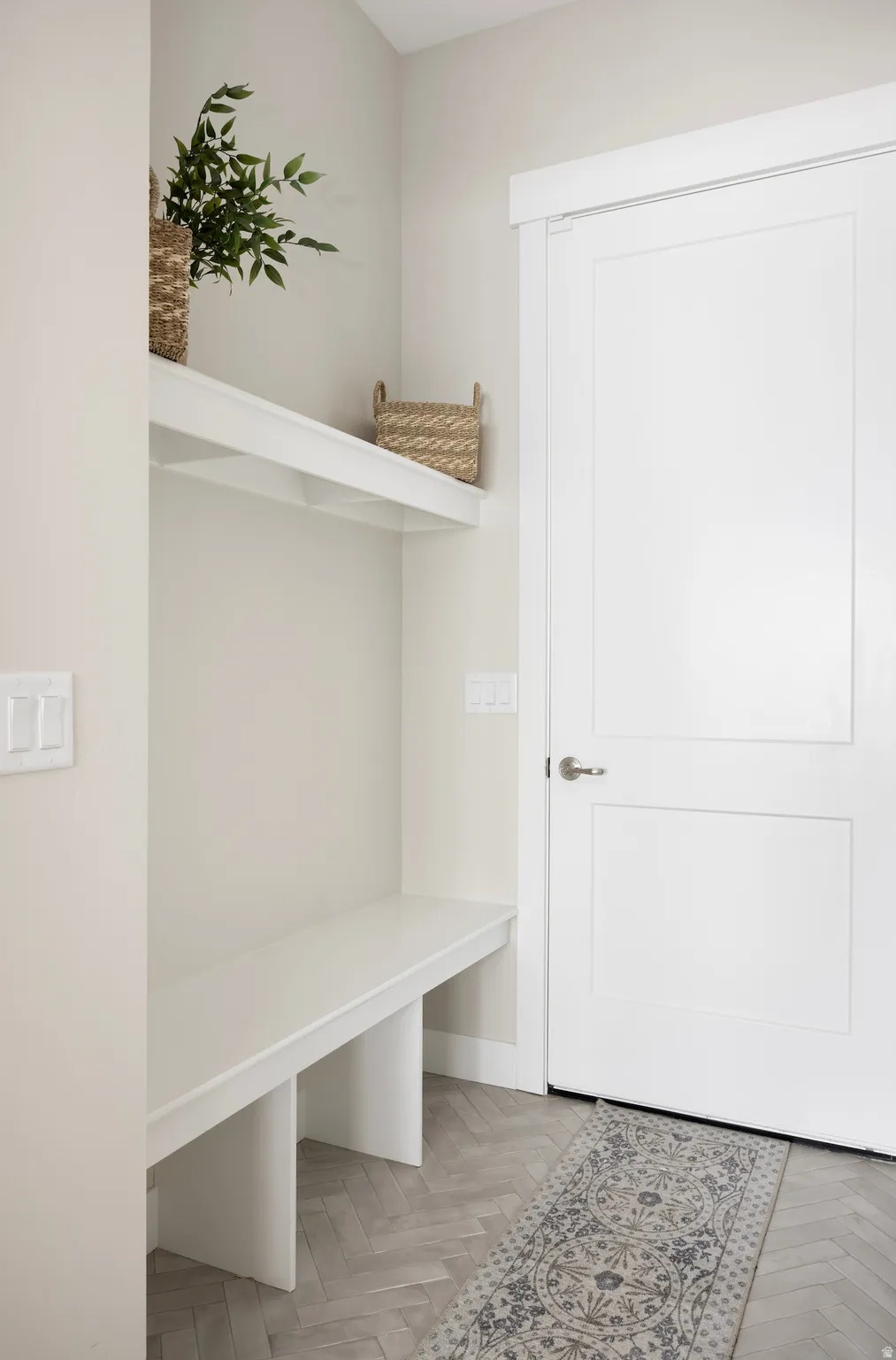 Mudroom with parquet flooring