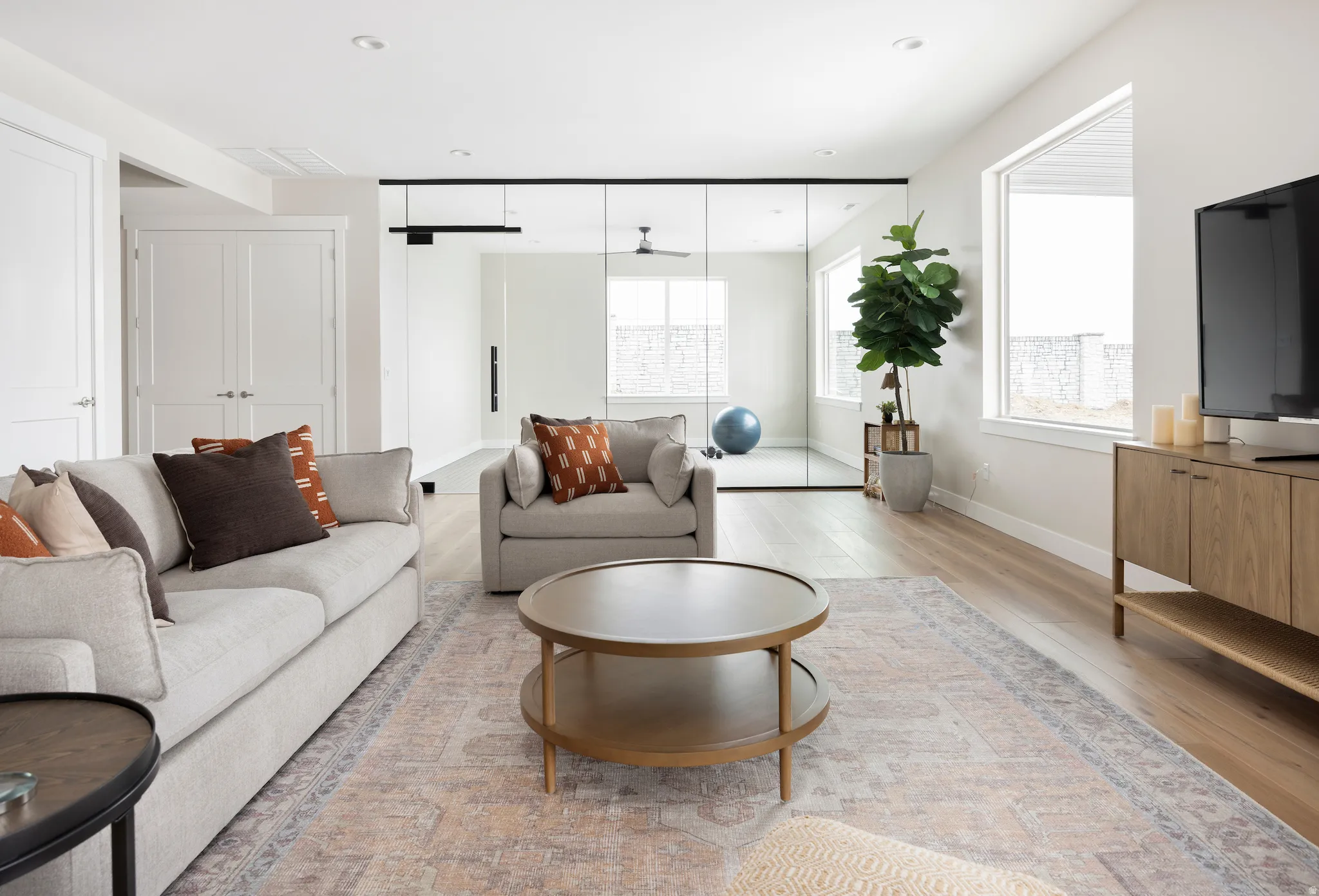 Living area featuring light wood finished floors and recessed lighting