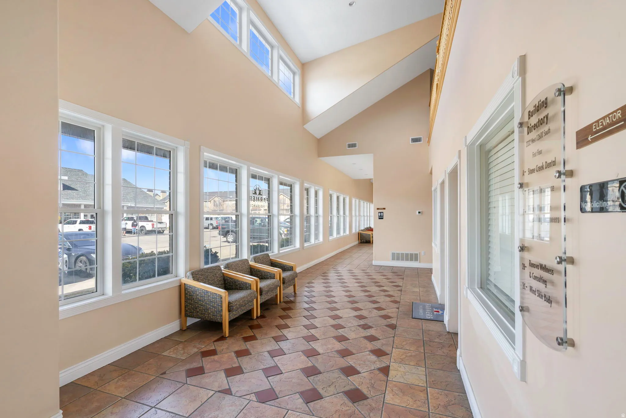 Corridor with baseboards and lofted ceiling