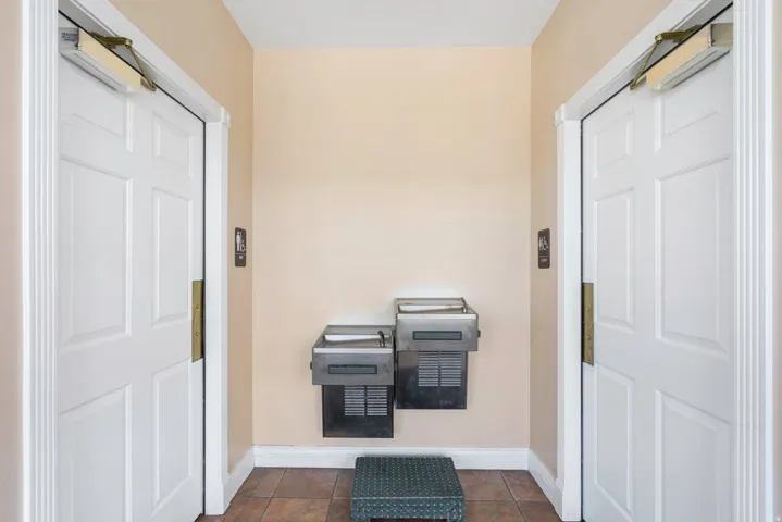 Entryway with baseboards and tile patterned floors