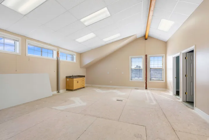 Additional living space with plenty of natural light and vaulted ceiling