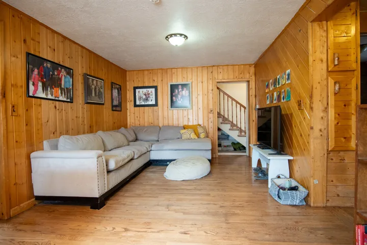 Family room with wood finished floors walls