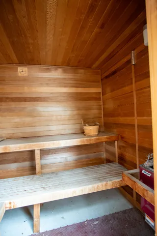 Sauna with wood walls and concrete flooring