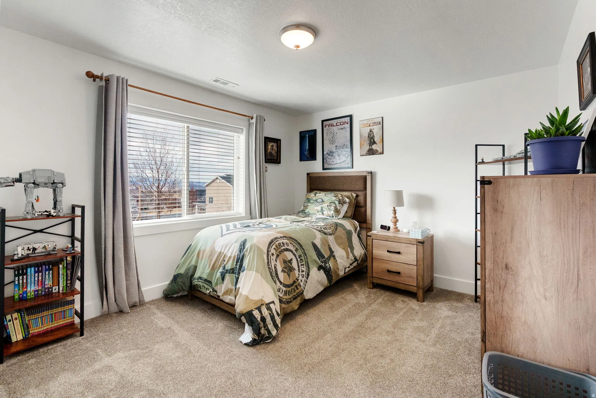Bedroom featuring baseboards and light carpet