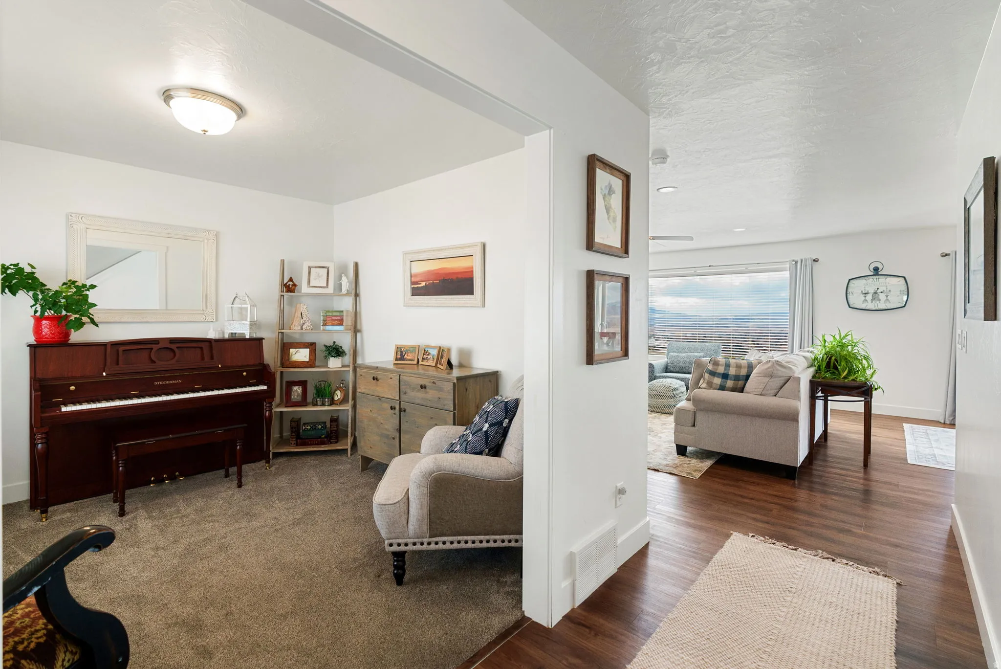 Living area featuring dark wood-style floors and a textured ceiling