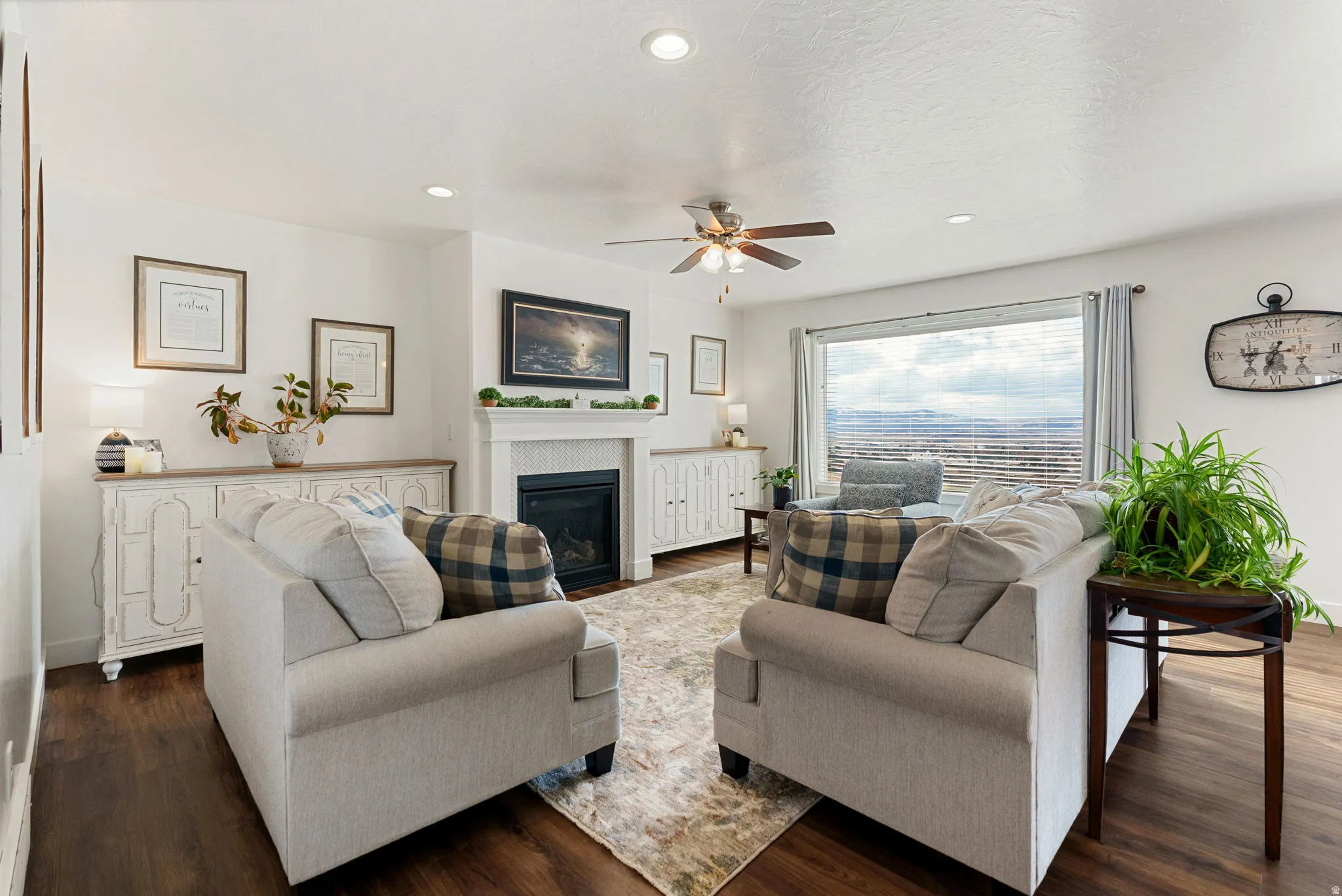 Living room with dark wood-style floors, a ceiling fan, recessed lighting, and a fireplace with flush hearth