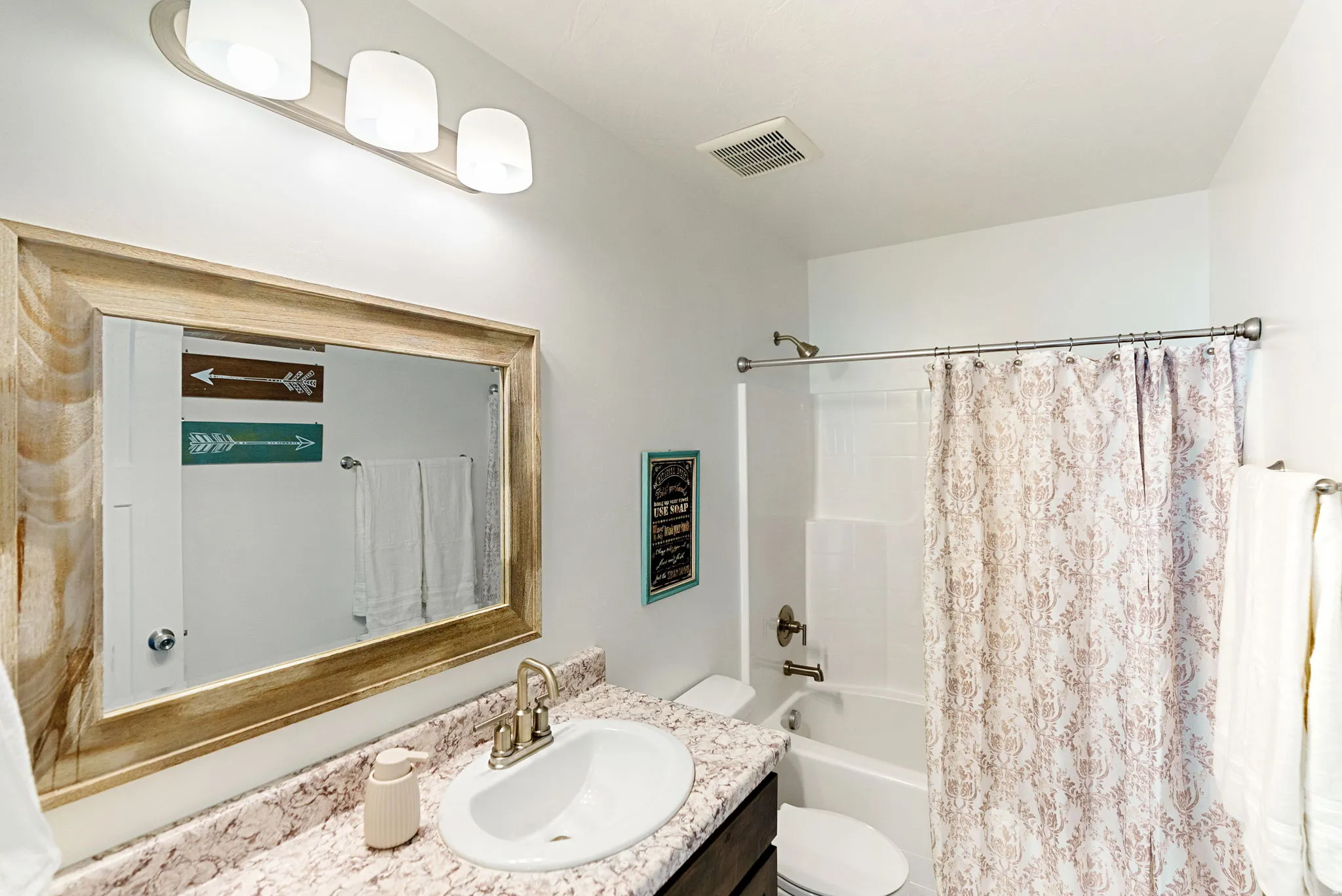 Full bath featuring vanity and shower / bathtub combination with curtain