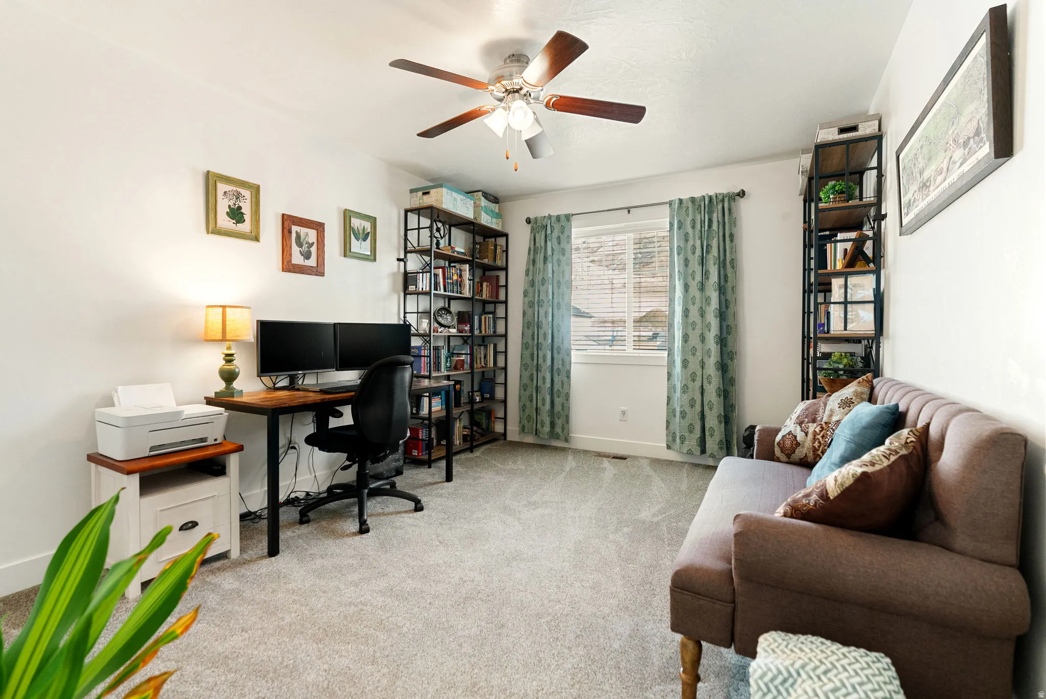 Office featuring light colored carpet and a ceiling fan
