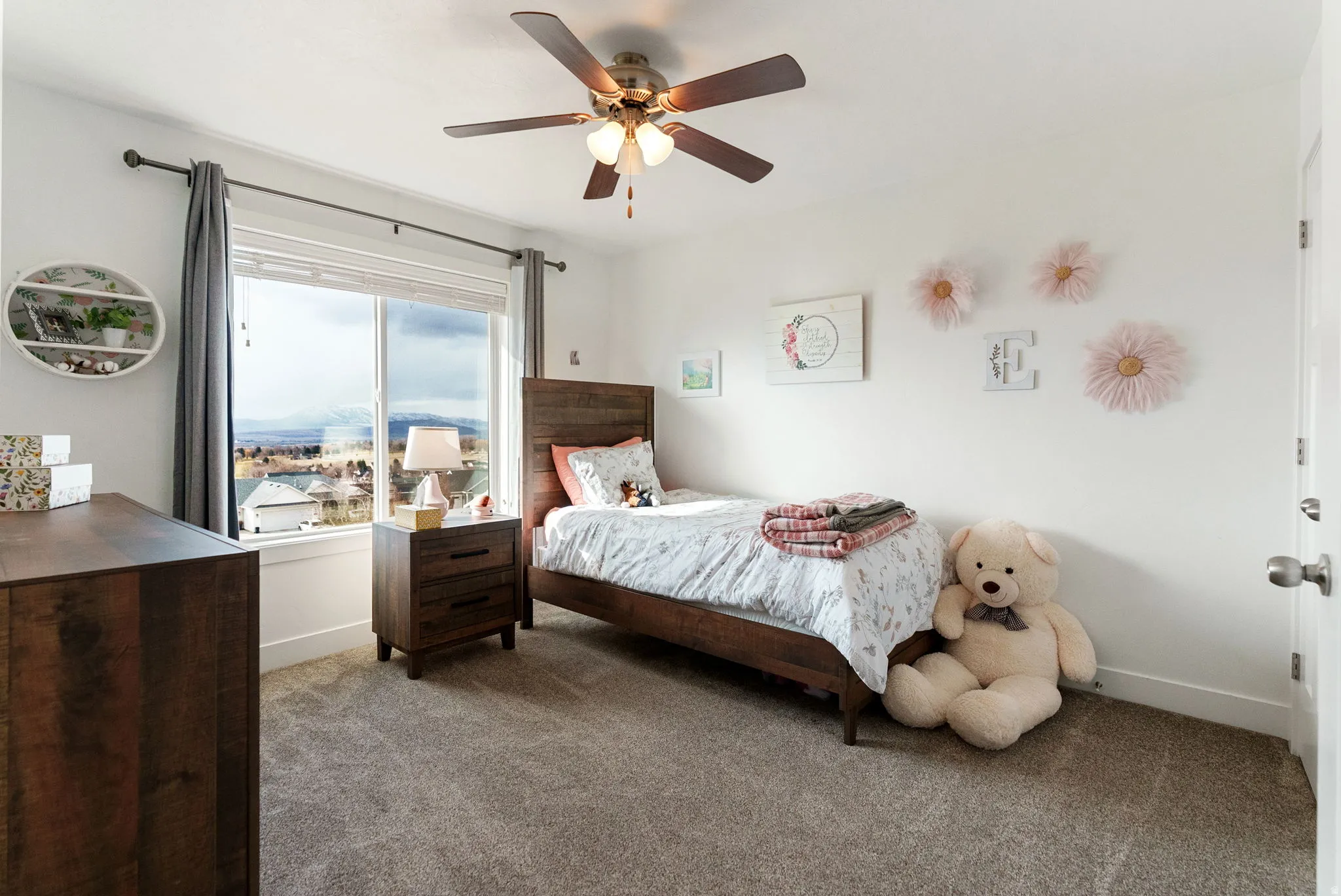 Bedroom with dark carpet and a ceiling fan