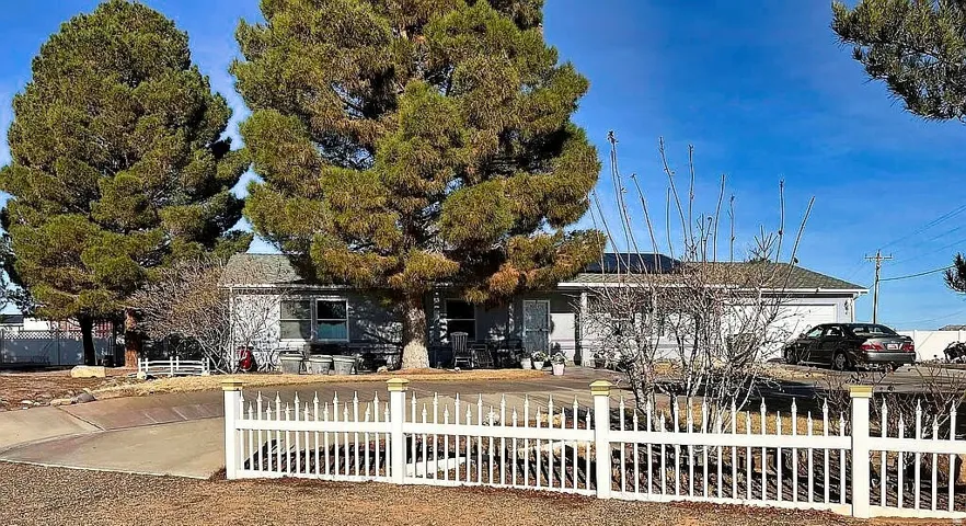 View of front of home with a fenced front yard and an attached garage