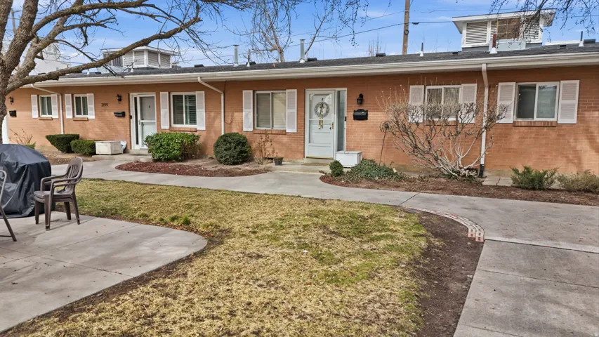 View of front of home with brick siding and a front lawn