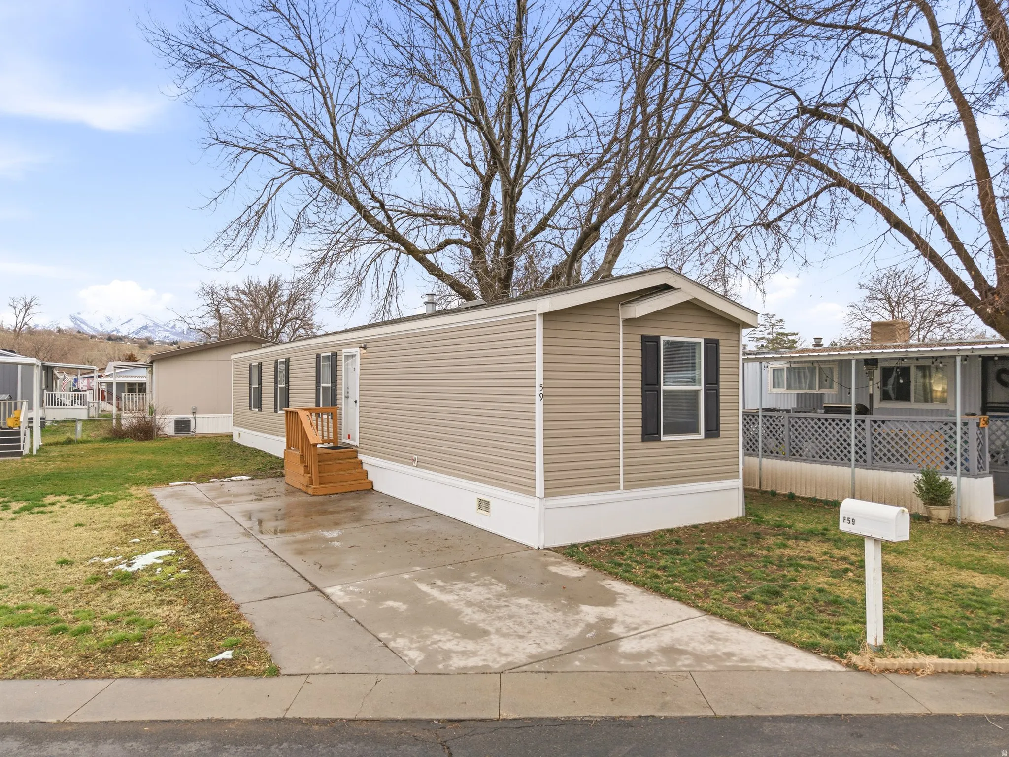 Manufactured / mobile home featuring a front lawn and crawl space