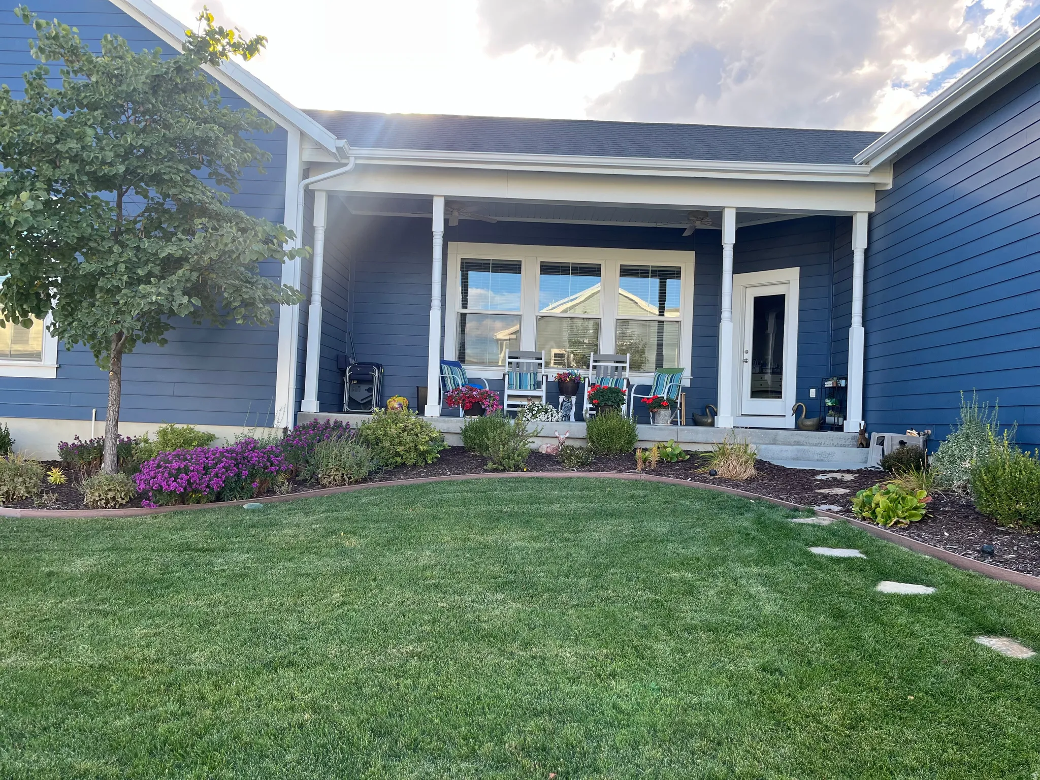 Side patio with lovely plantings, ceiling fans and great views