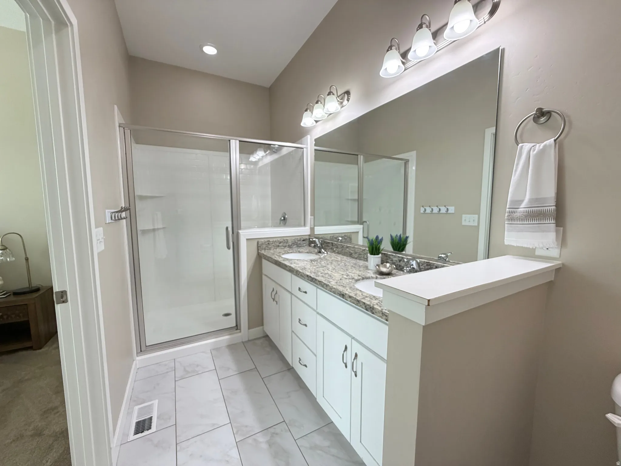 Dual sinks, large walk in shower in primary bathroom