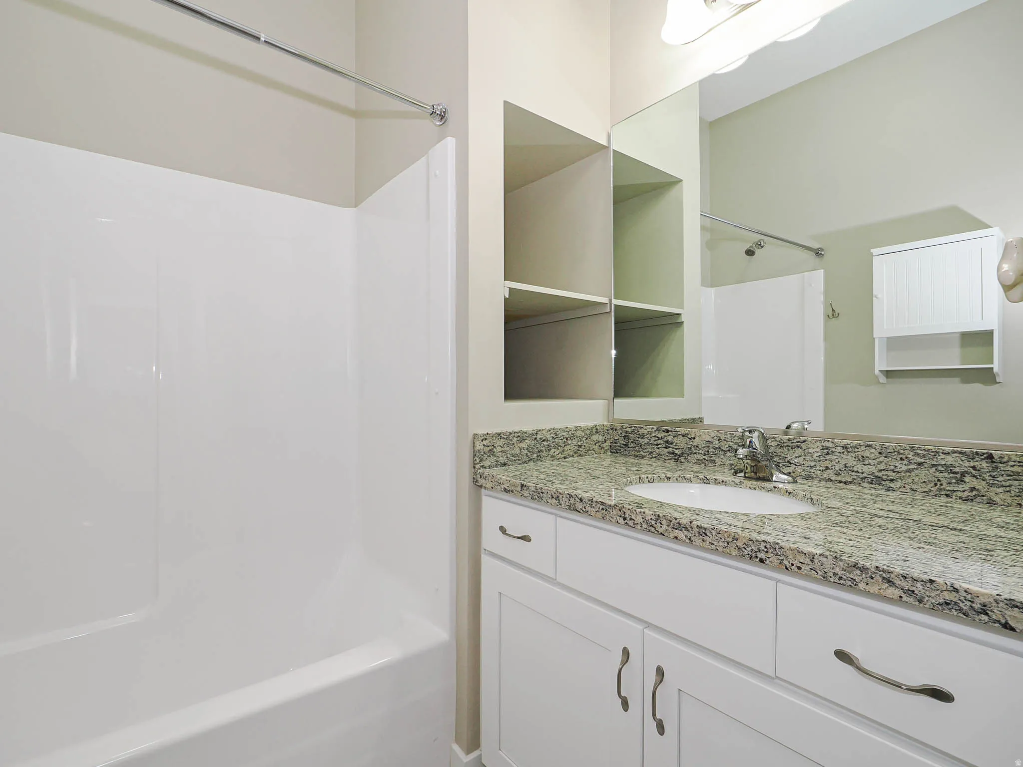 Hall bath with granite counters and tub shower combo