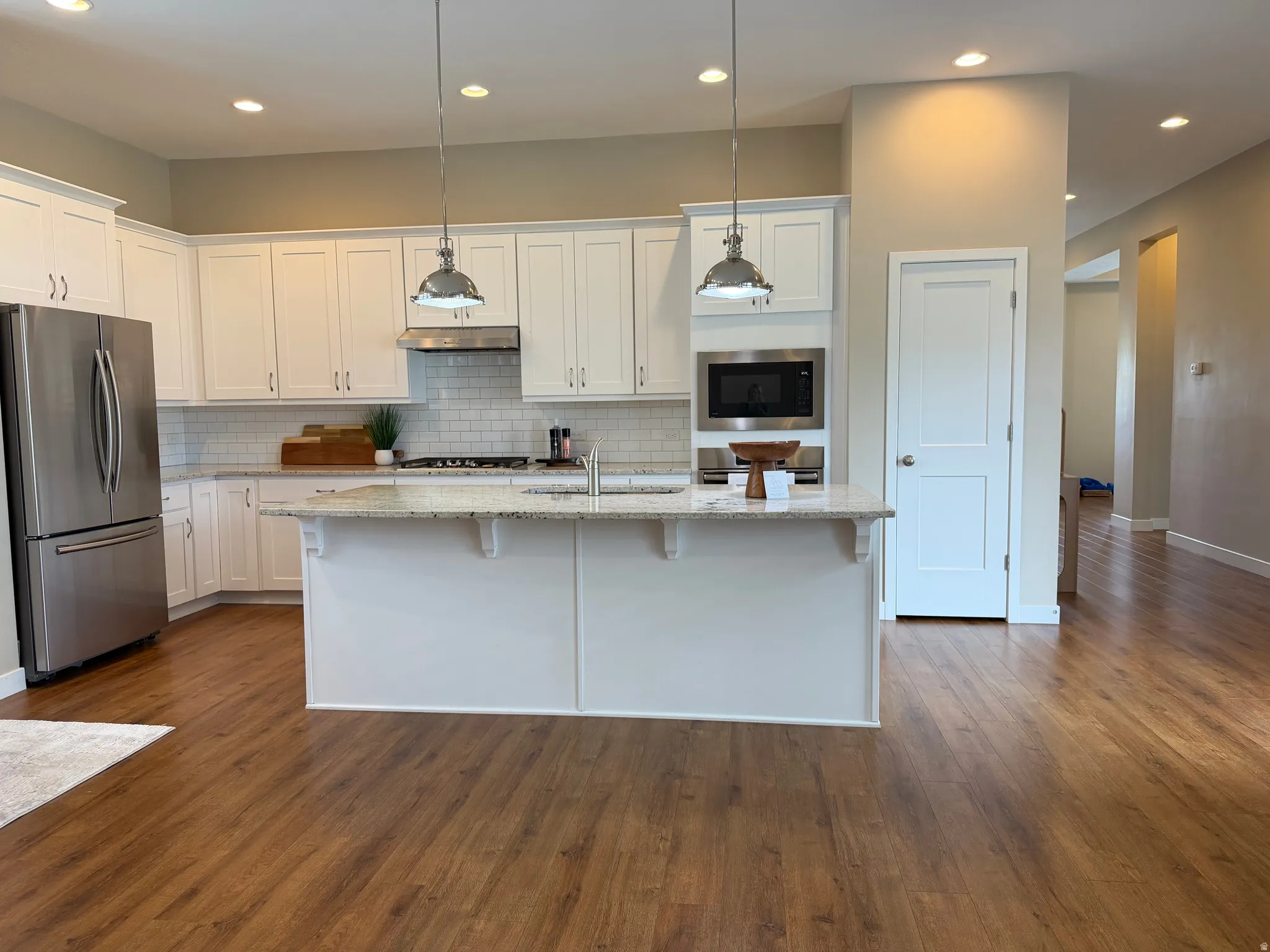 Kitchen with stainless steel appliances and granite counters
