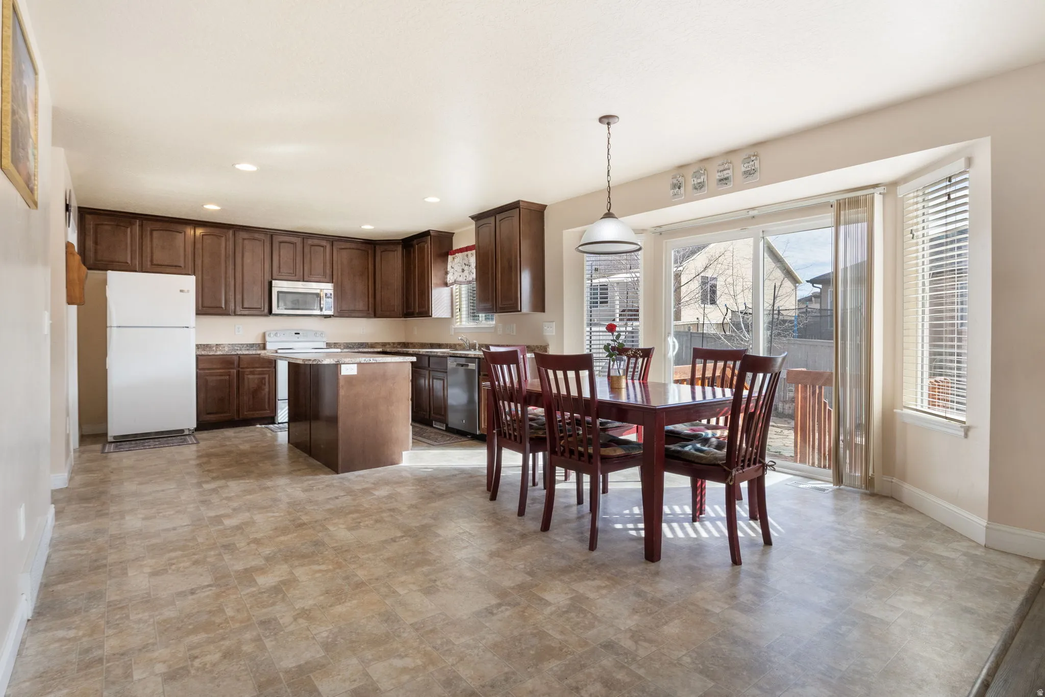 Dining area featuring stone finish floors and recessed lighting