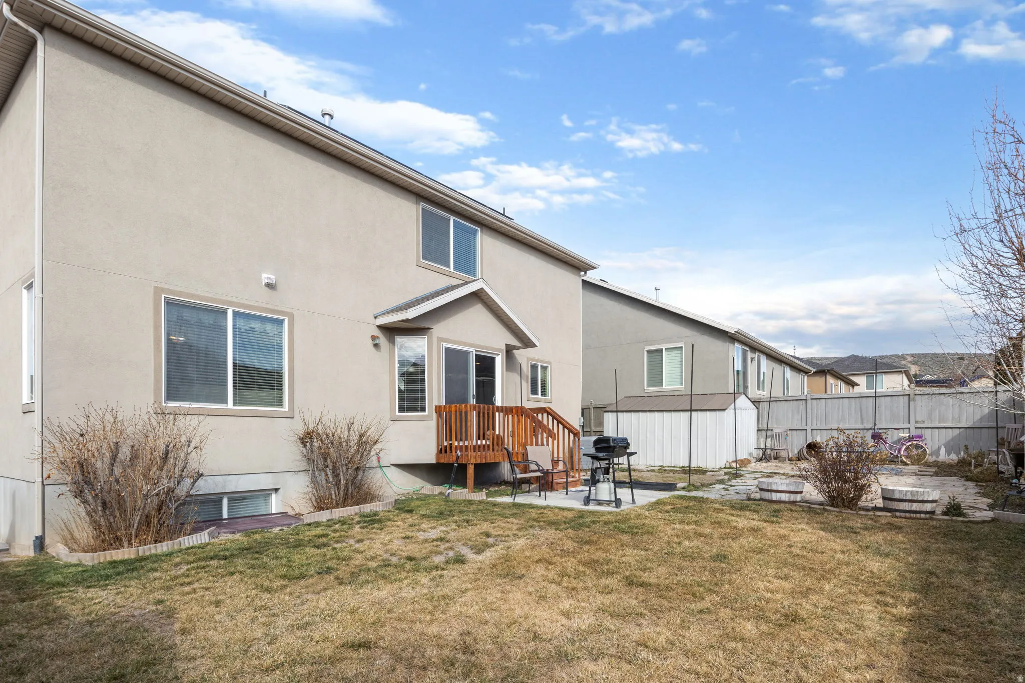 Back of house featuring a patio area and stucco siding
