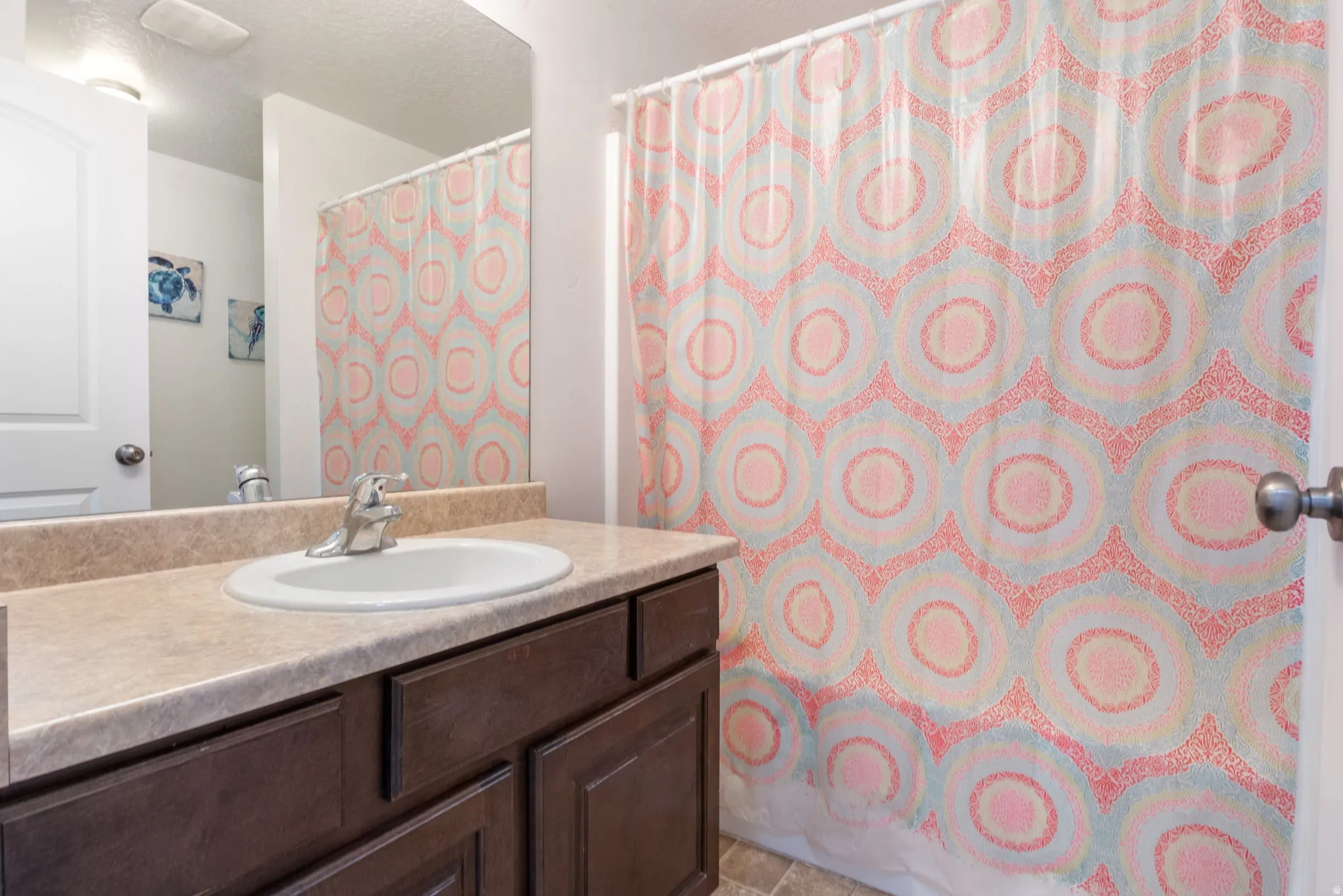 Bathroom featuring vanity, a shower with shower curtain, and a textured ceiling