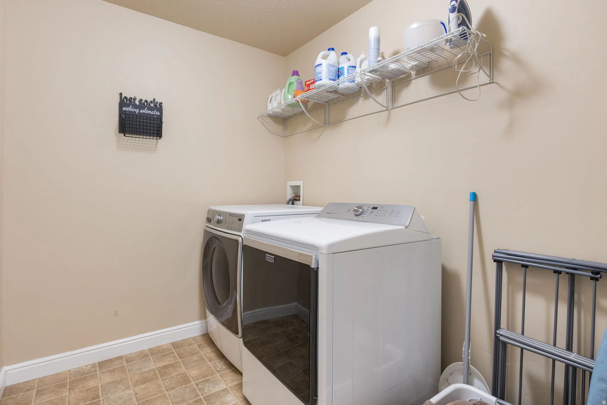 Laundry room featuring baseboards and washer and dryer