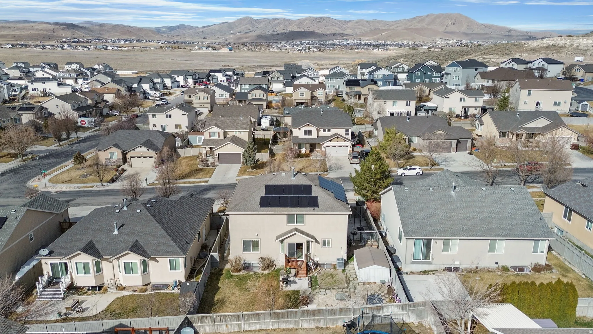 Aerial view of residential area featuring a mountainous background