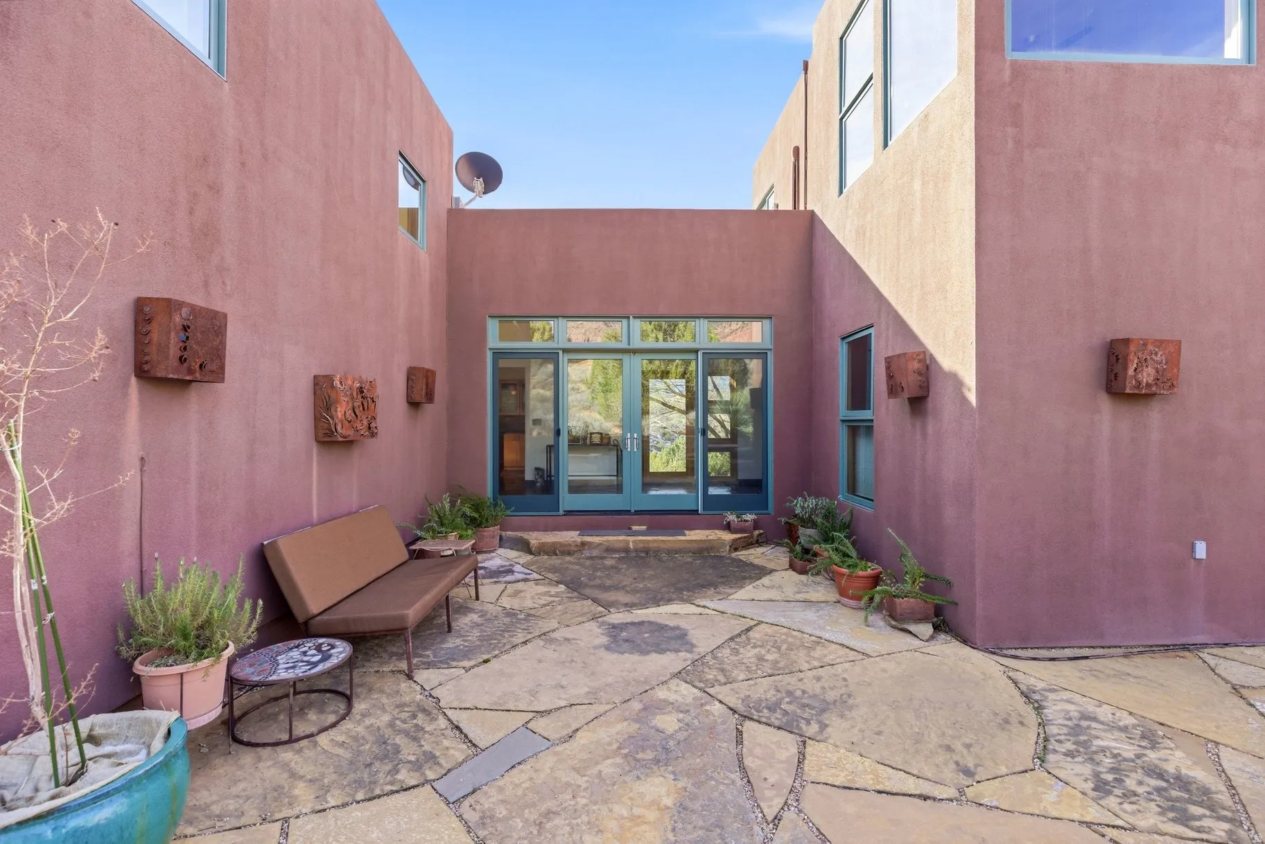 Entrance to property with a patio area, french doors, and stucco siding