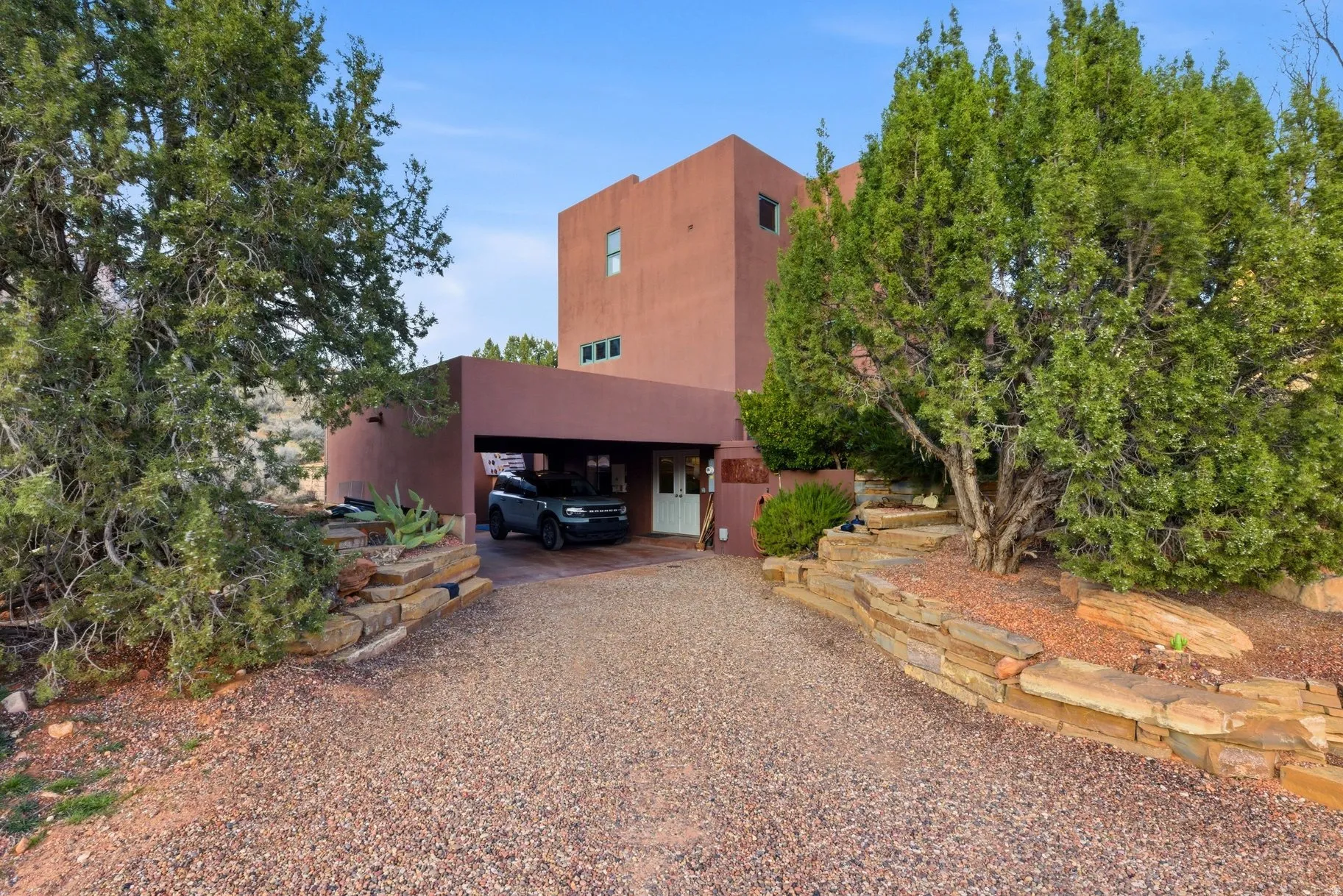View of front of property featuring stucco siding and a carport