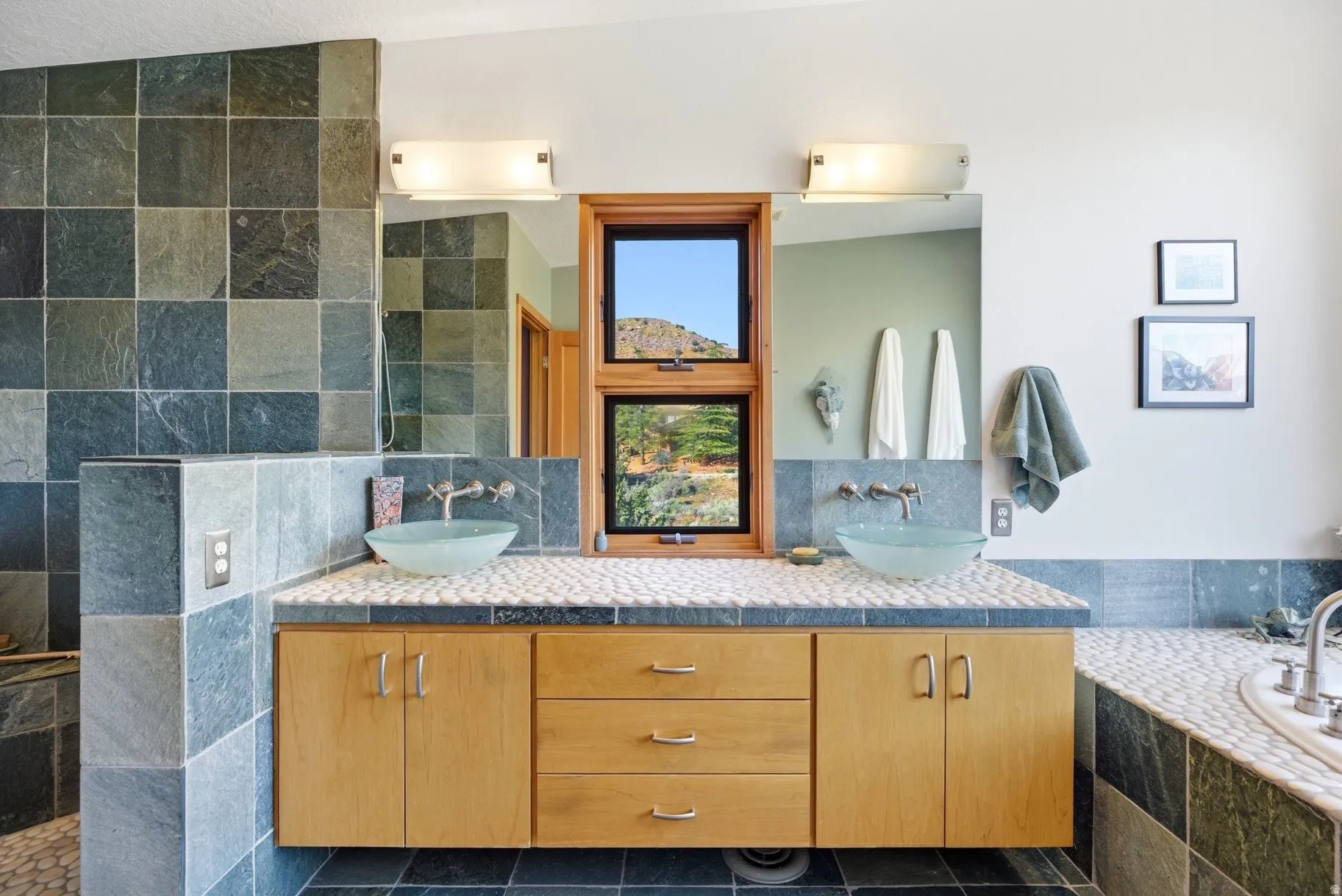 Full bathroom featuring double vanity, backsplash, a bath, and walk in shower