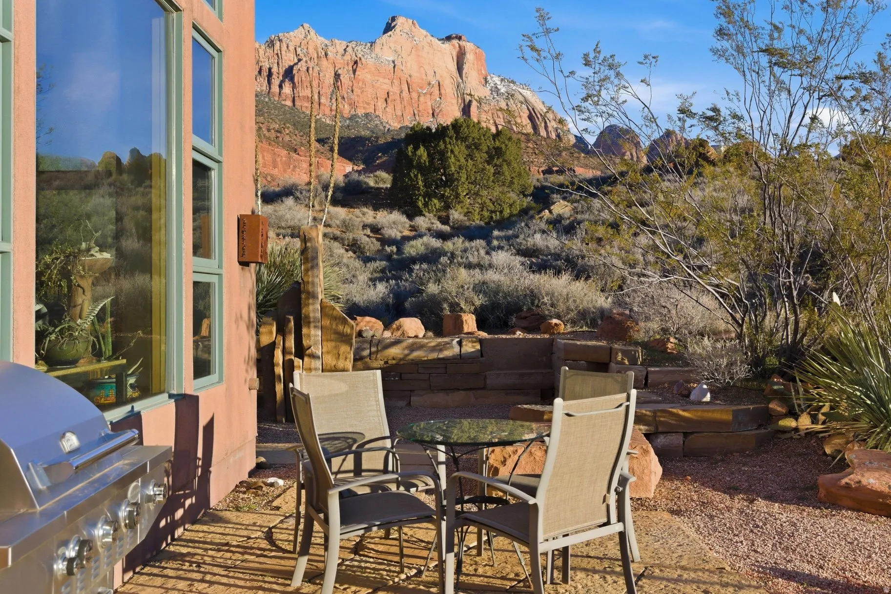 View of patio featuring area for grilling, outdoor dining area, and a mountain view
