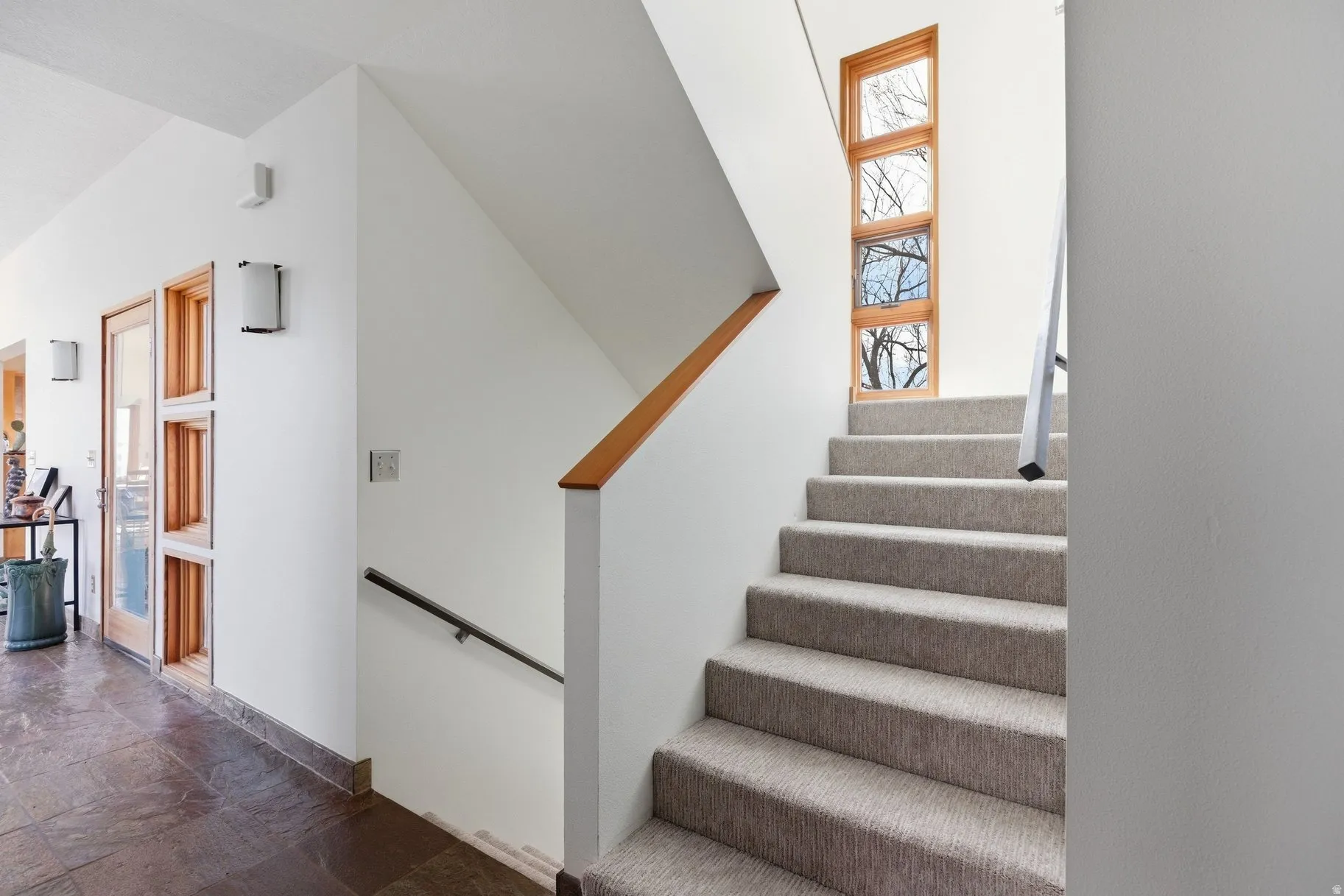 Staircase with stone tile floors