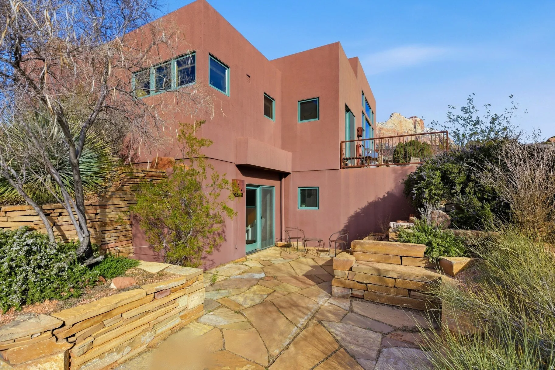 Back of property featuring a patio and stucco siding