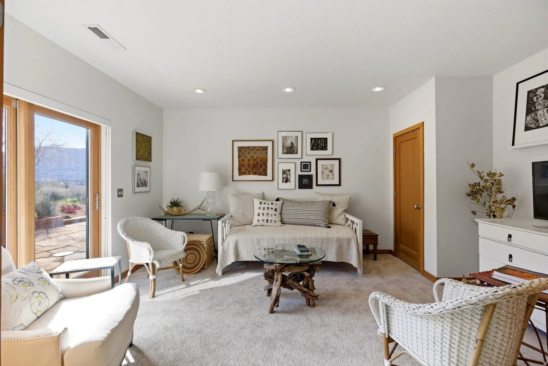 Living area featuring light colored carpet and recessed lighting
