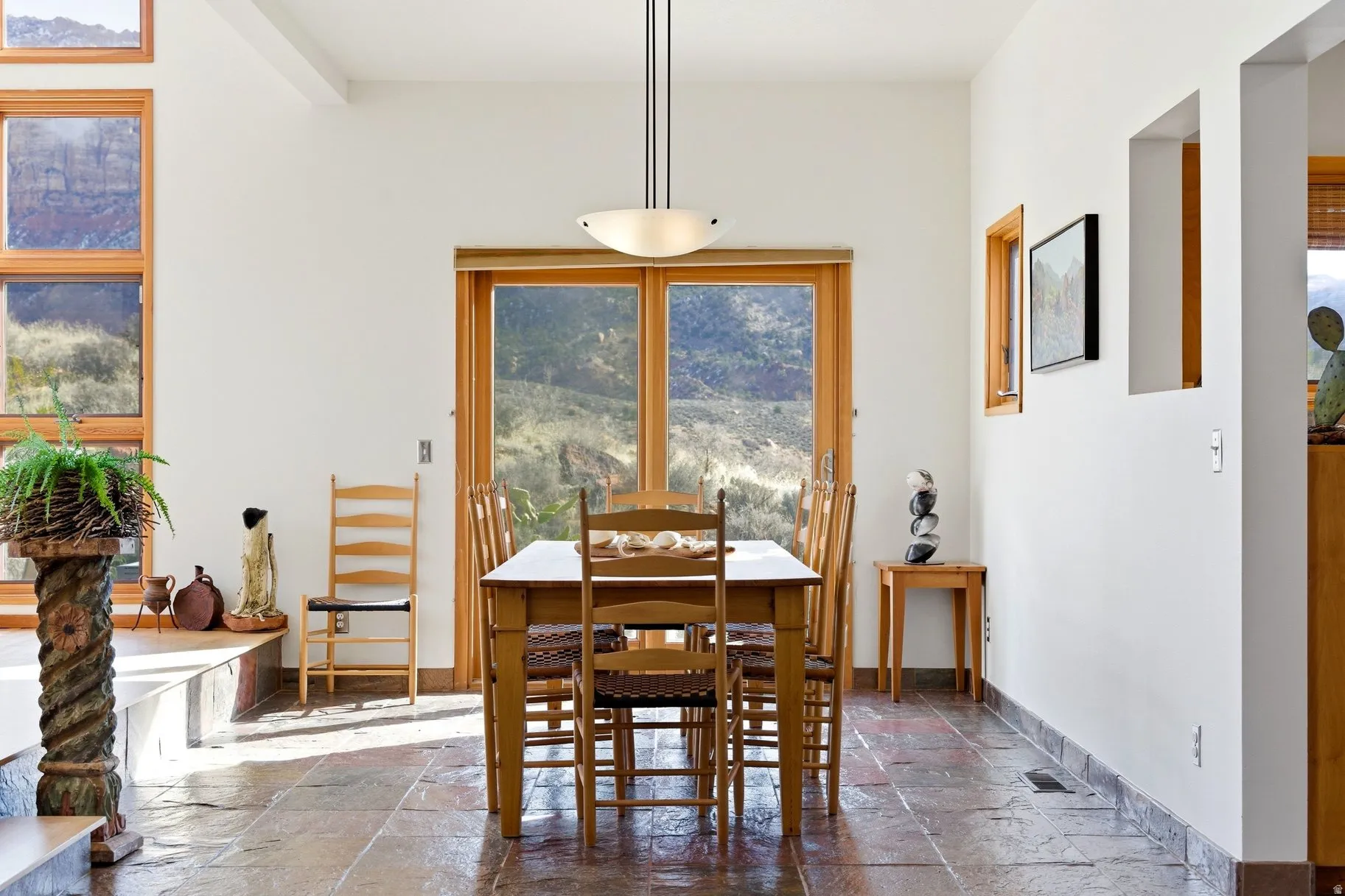 Dining area with stone tile flooring and baseboards