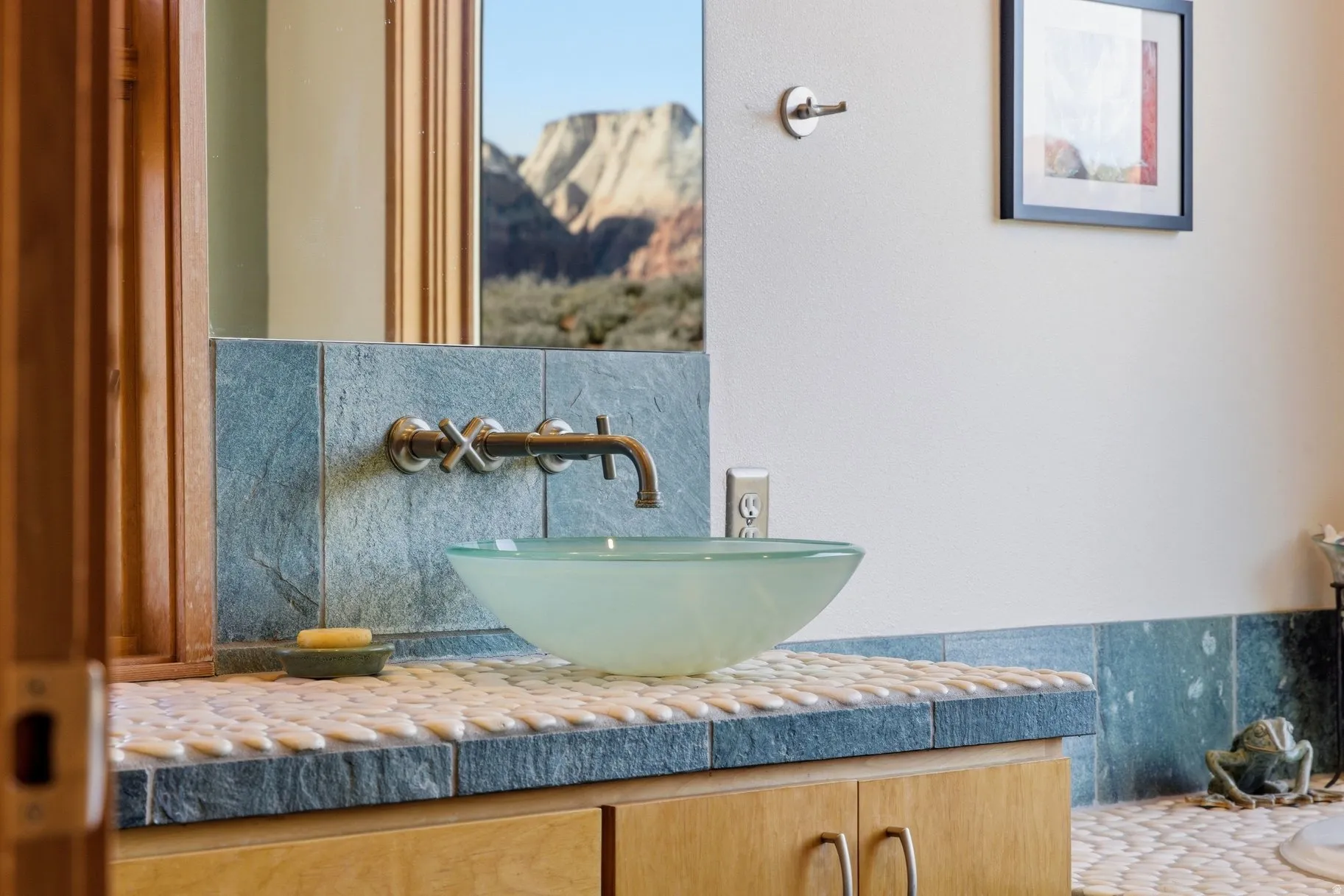 Bathroom featuring vanity and backsplash