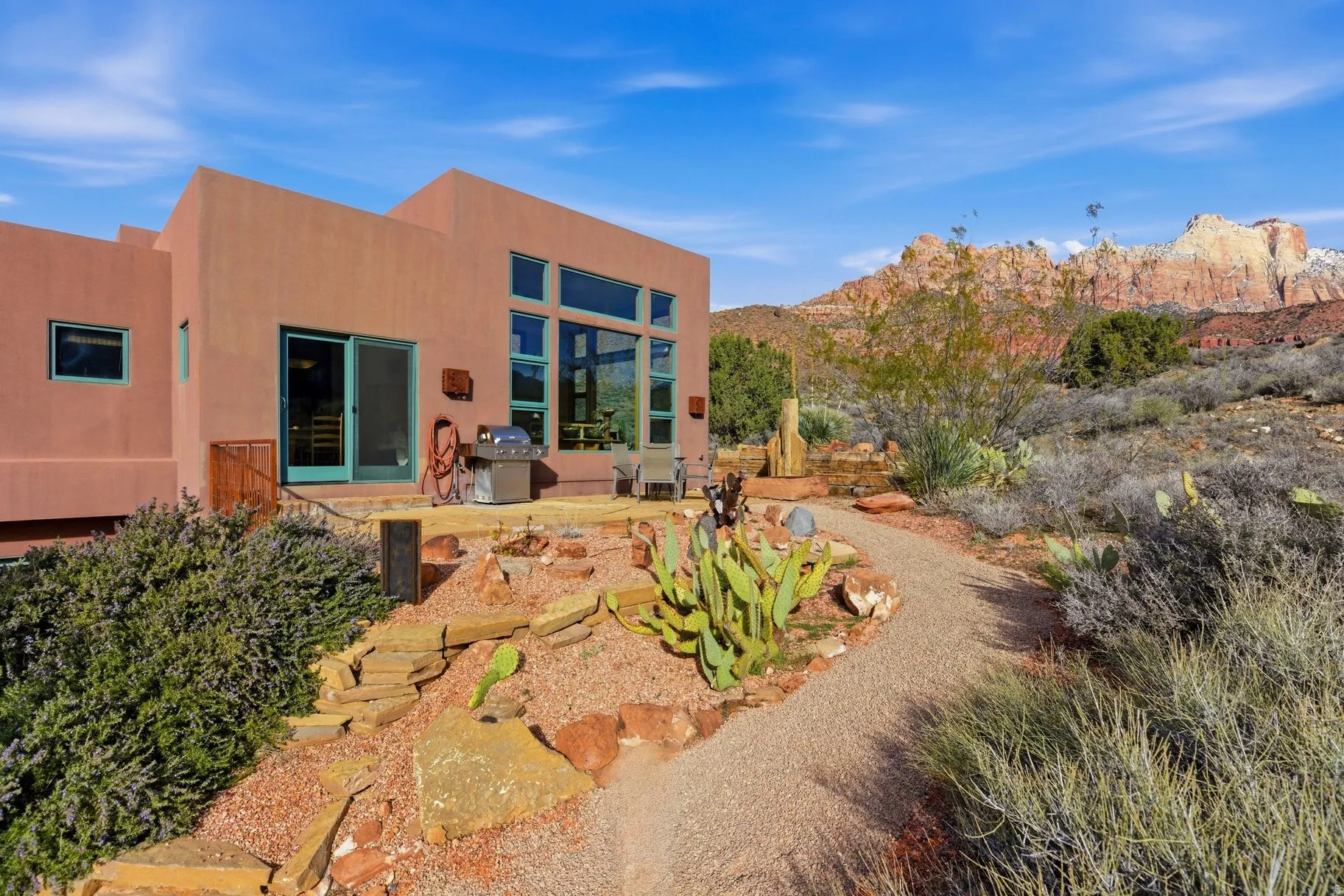 Rear view of property with a patio, stucco siding, and a mountain view