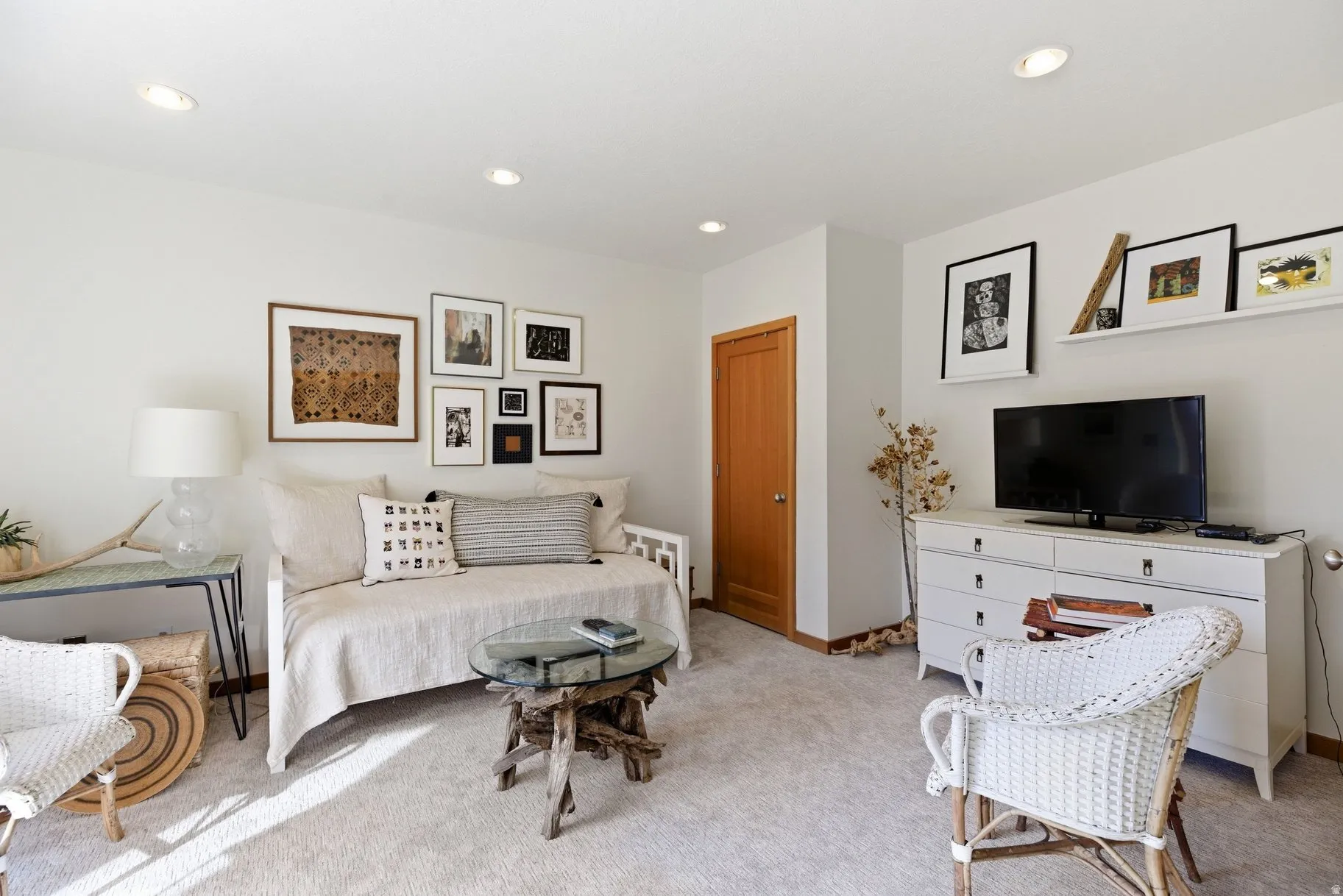 Living room with light colored carpet and recessed lighting