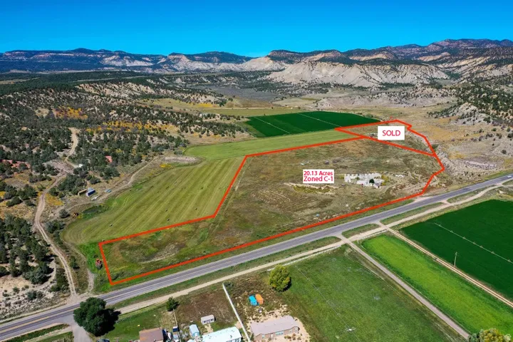 Overview of rural landscape featuring property parcel outlined and a mountainous background