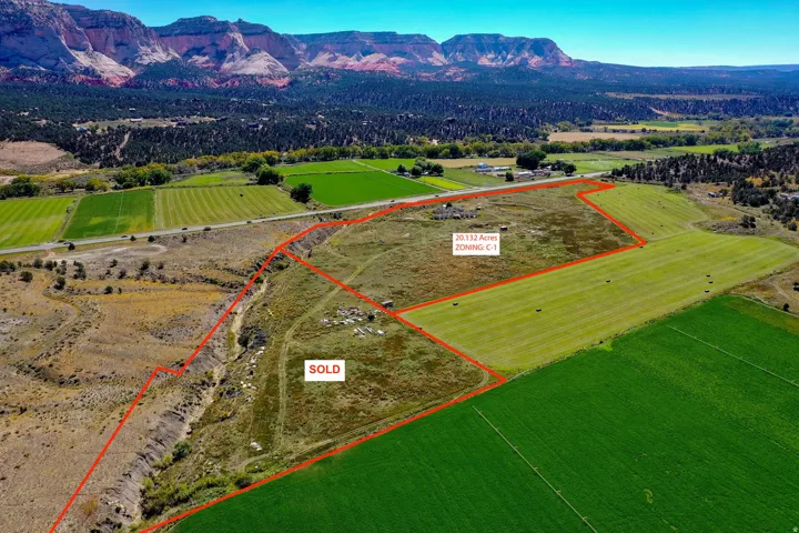 Overview of rural landscape featuring property parcel outlined and a mountainous background