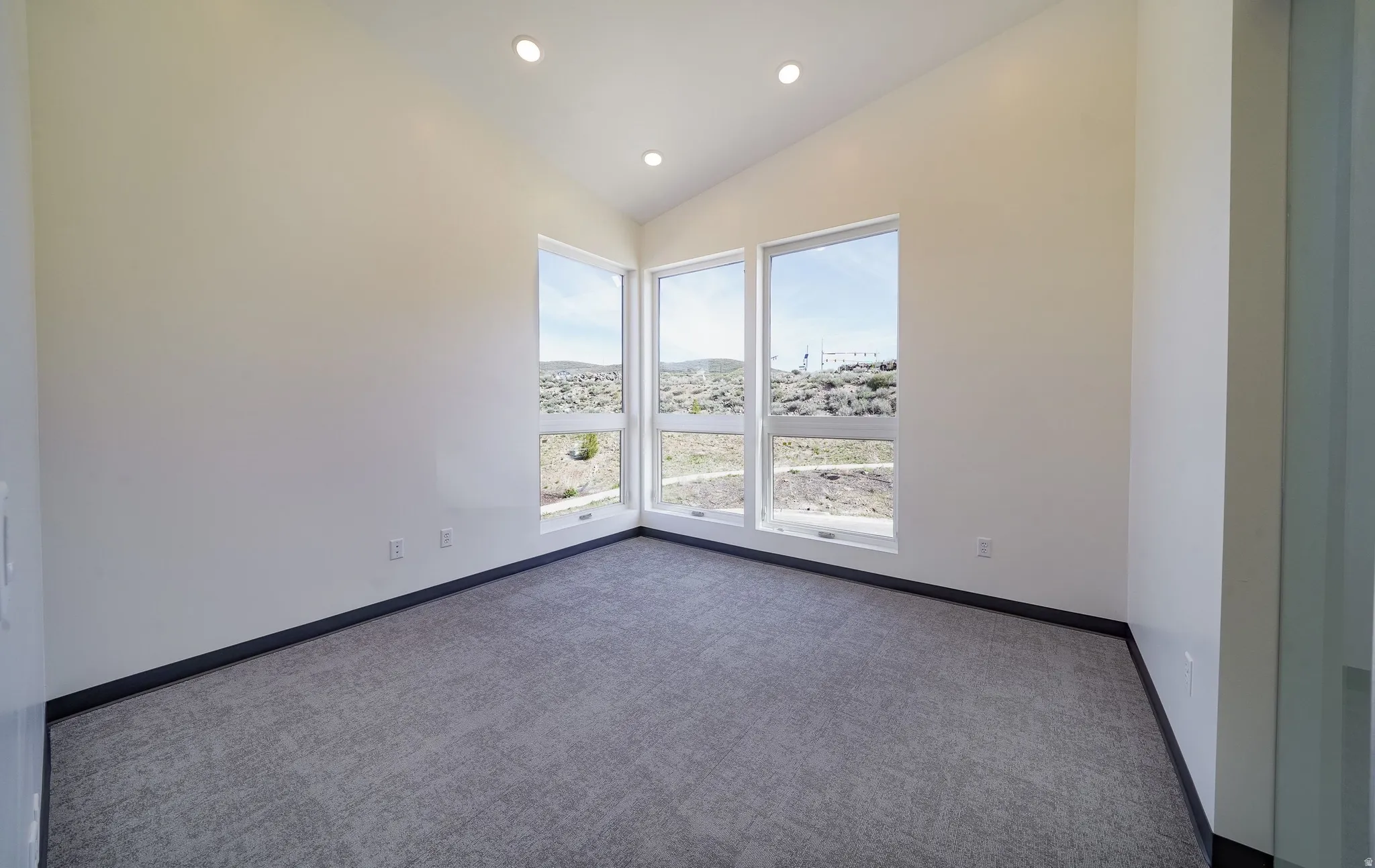 Empty room with carpet, recessed lighting, and lofted ceiling