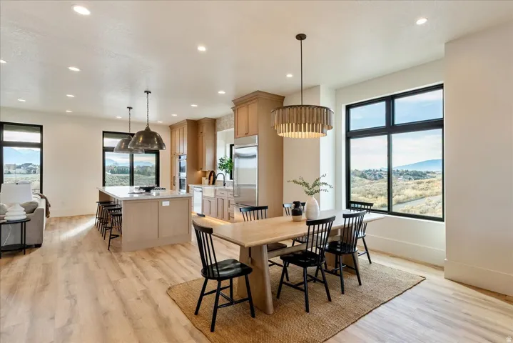 Dining area featuring light wood-style flooring, recessed lighting, and a mountain view