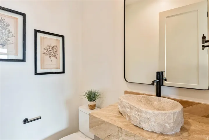 Half bath featuring toilet and vanity