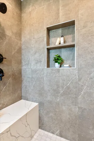 Full bath featuring a tile shower