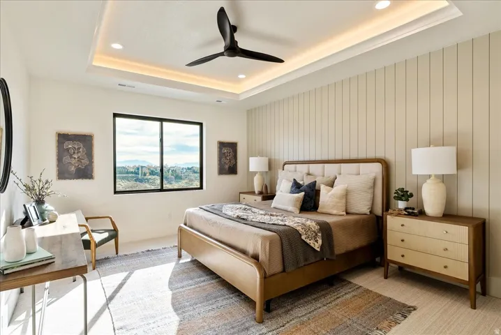 Bedroom featuring a ceiling fan, recessed lighting, and a tray ceiling