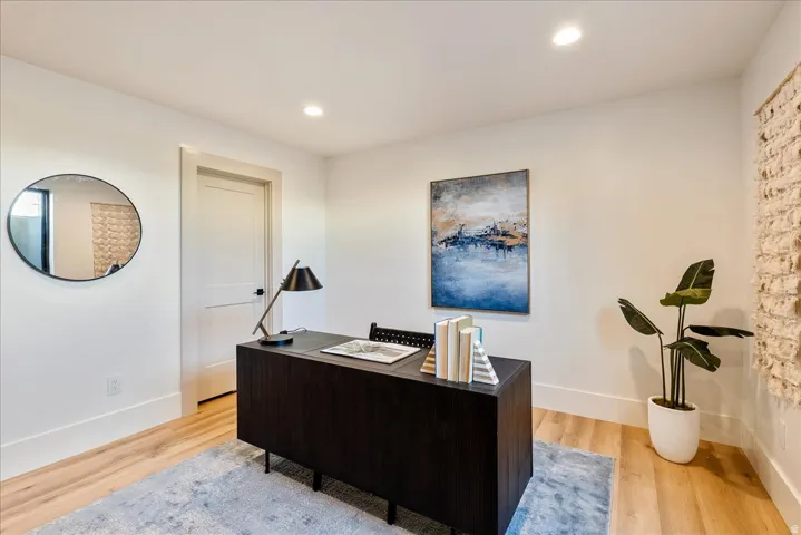 Office area featuring light wood finished floors and recessed lighting