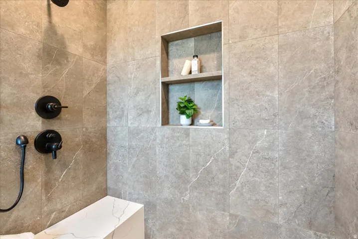 Full bath featuring tiled shower