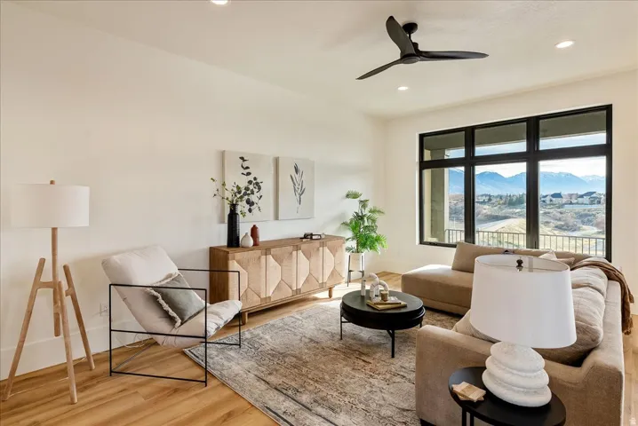 Living area featuring a mountain view, light wood finished floors, ceiling fan, and recessed lighting