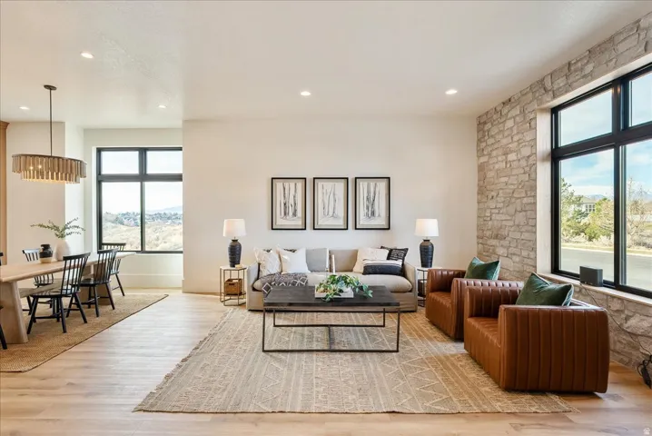 Living area with light wood finished floors and recessed lighting